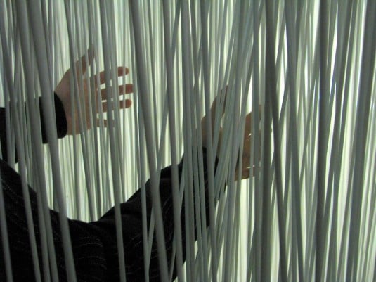 Tatsuo Yamaoto reeds with hands.