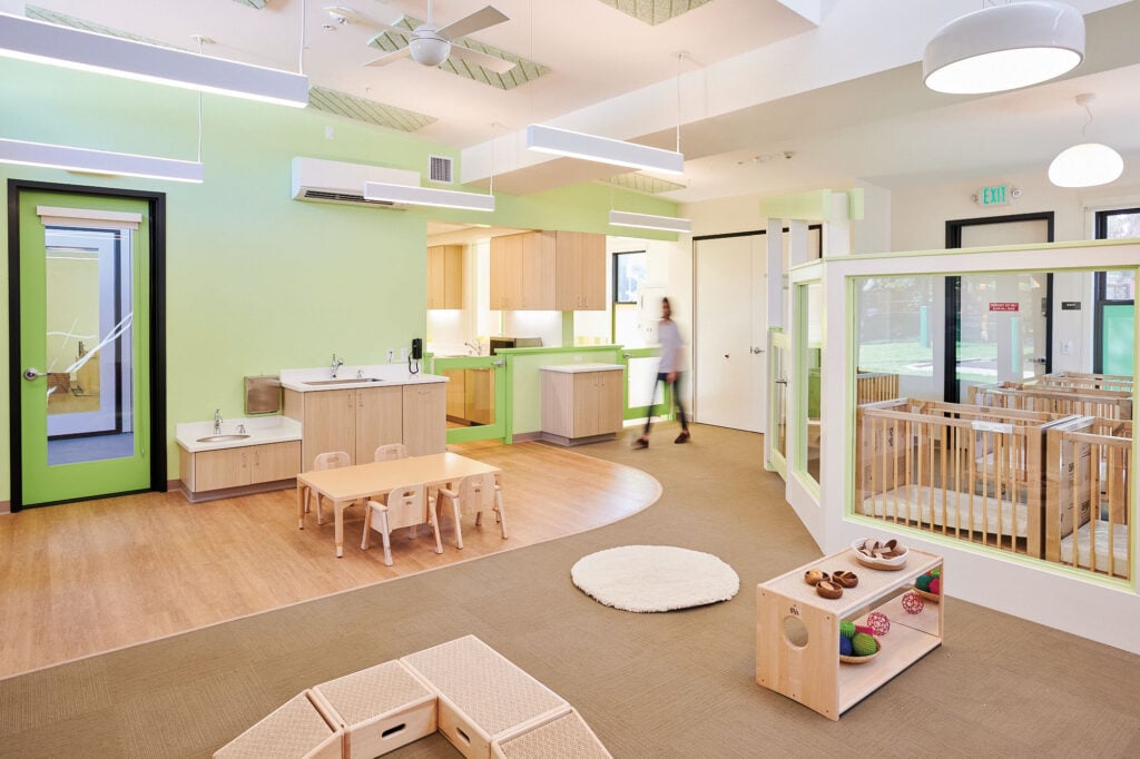 Daycare interior with green walls and wooden furniture