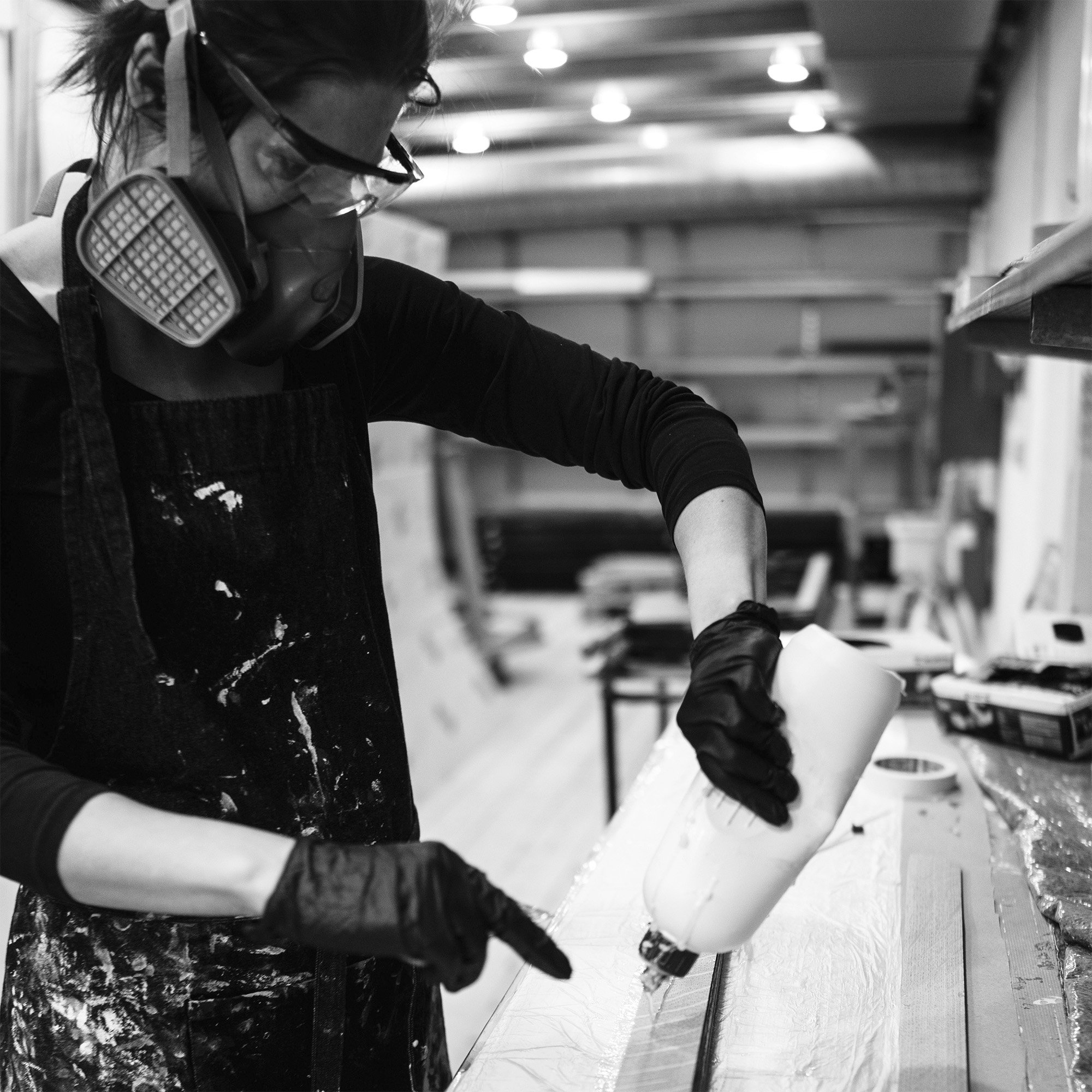 Boysen in her fabrication studio gluing pieces of material 