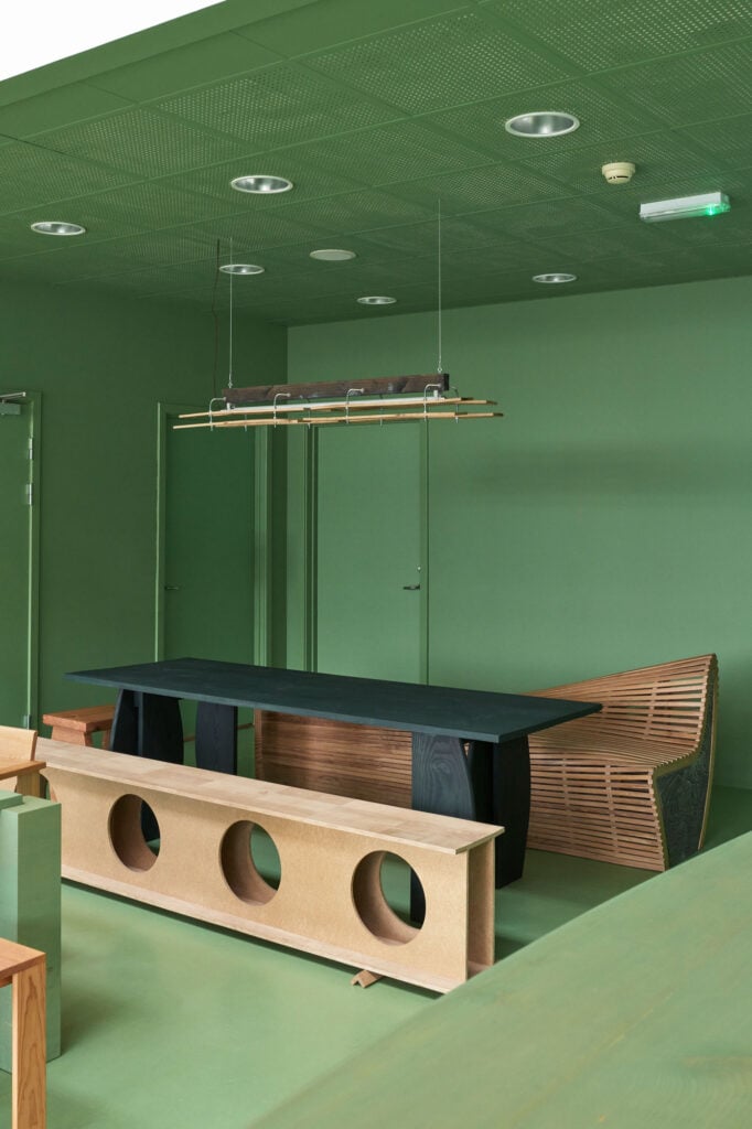 table and benches in a green room