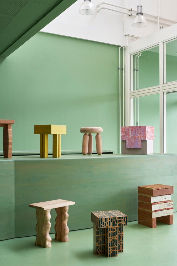 a selection of chairs displayed on top of the green bar