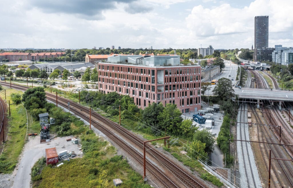 exterior of brick building by train tracks