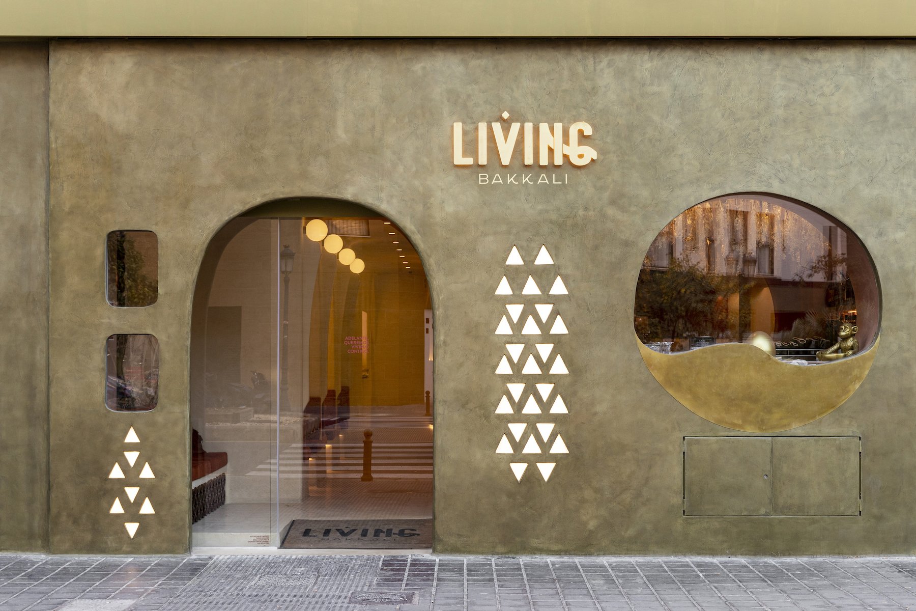 exterior of a restaurant with rounded windows, triangular lighting design ,and a sign that says "Living Bakkali"