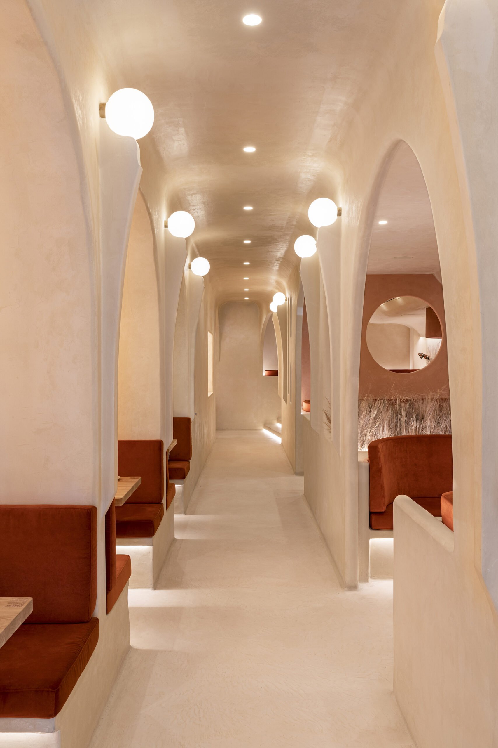 interior of a restaurant hall with various cut out booths and nooks for seating