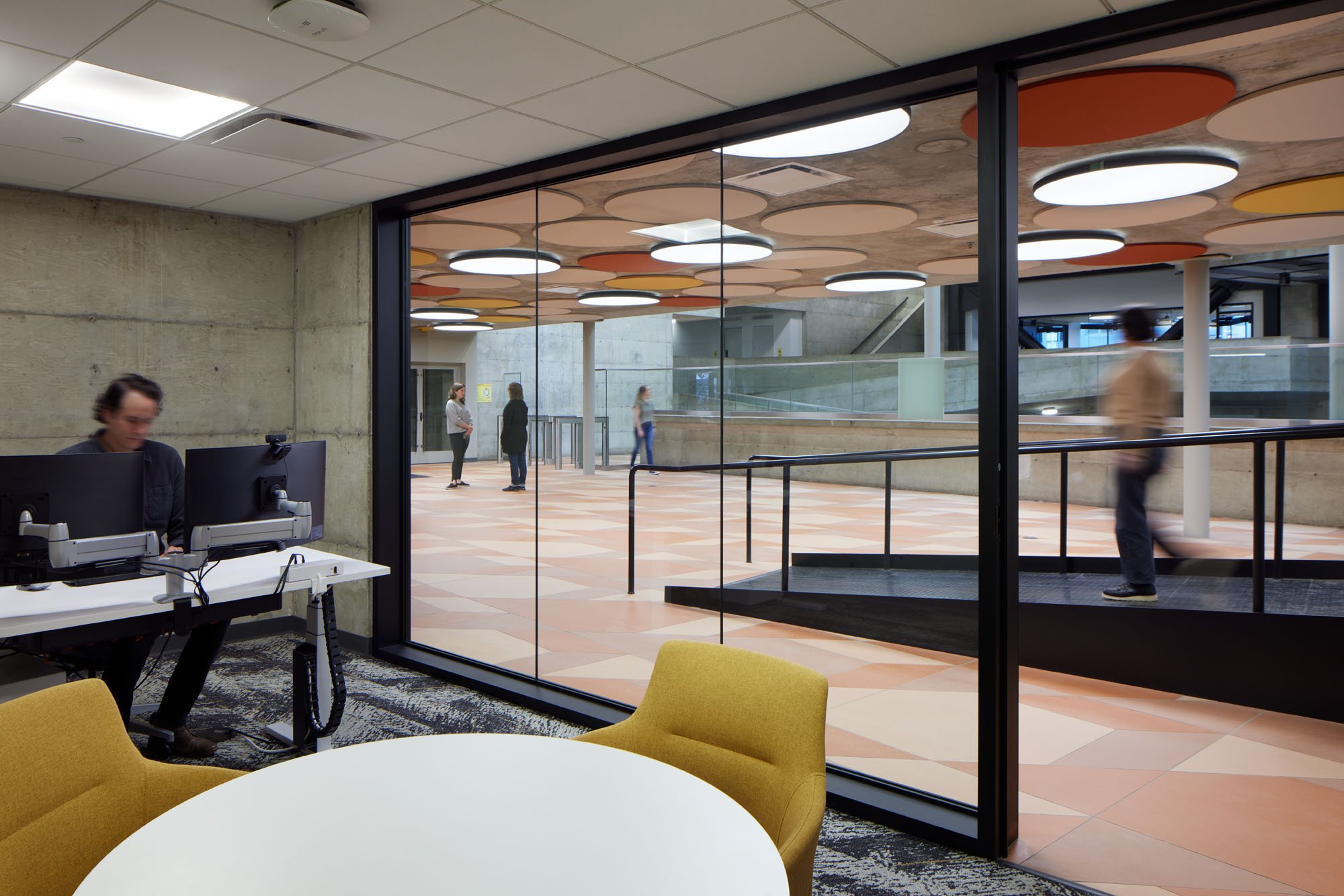 labs and offices view through glass wall to ramp