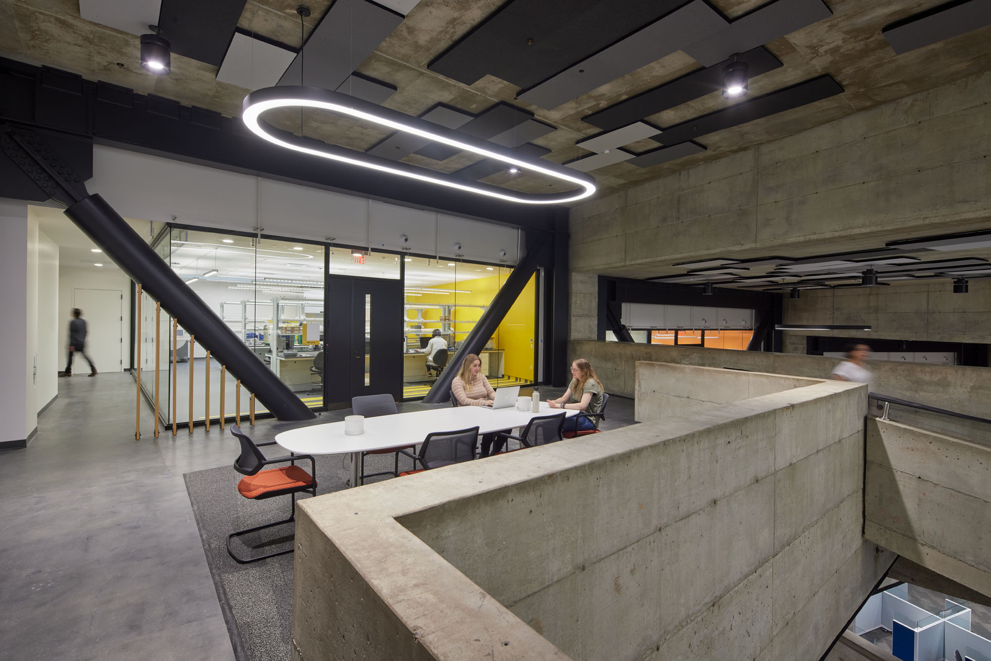 workspaces underneath a geometric lightfixture