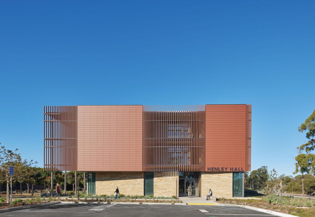 henley hall exterior, a terracotta red facade punctuated by brise-soleil wings