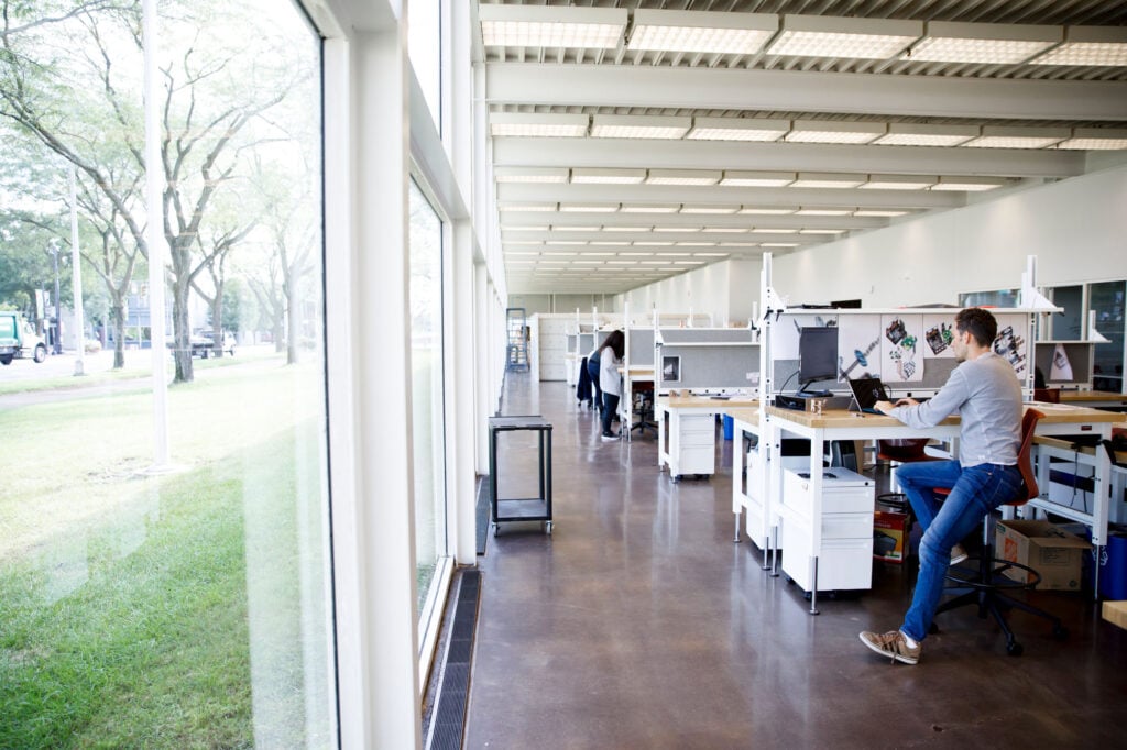 students at desks inside modernist building