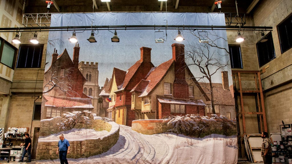 backdrop depicting a snowy village street inside a performance space