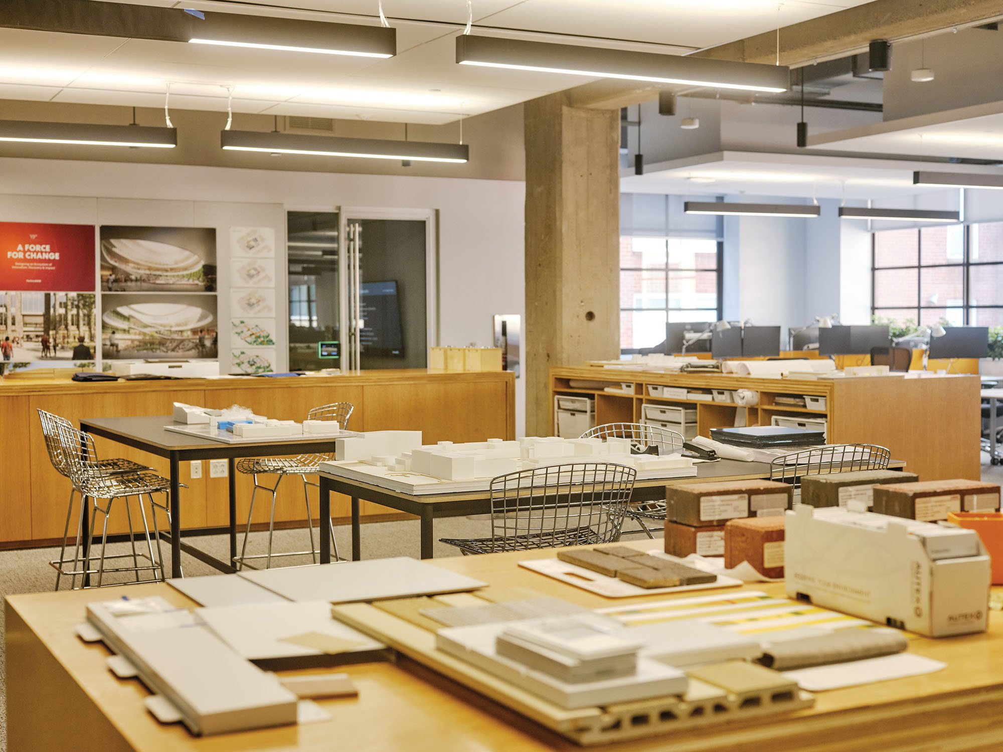 image of architecture office with models, material samples, tables and desks