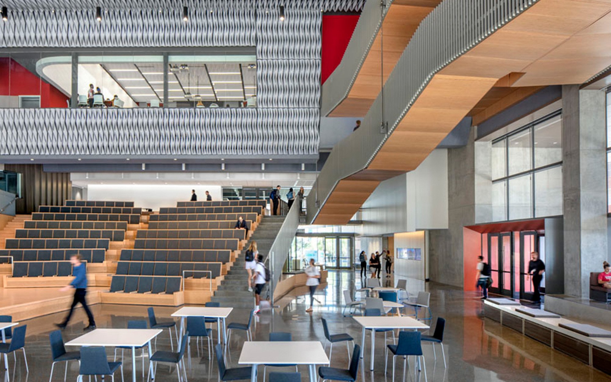 An interior image of an seating area in a large atrium within an educational building