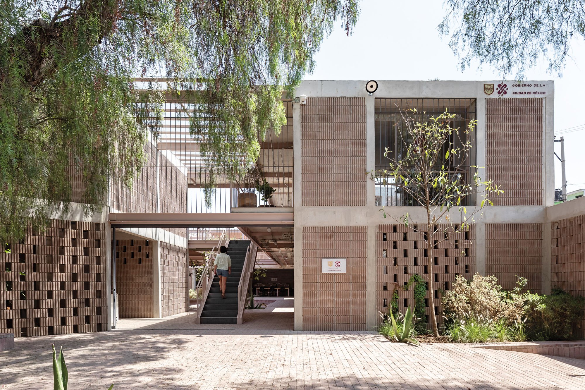 a photograph of the exterior of a brick and cement pilares building in Mexico city 