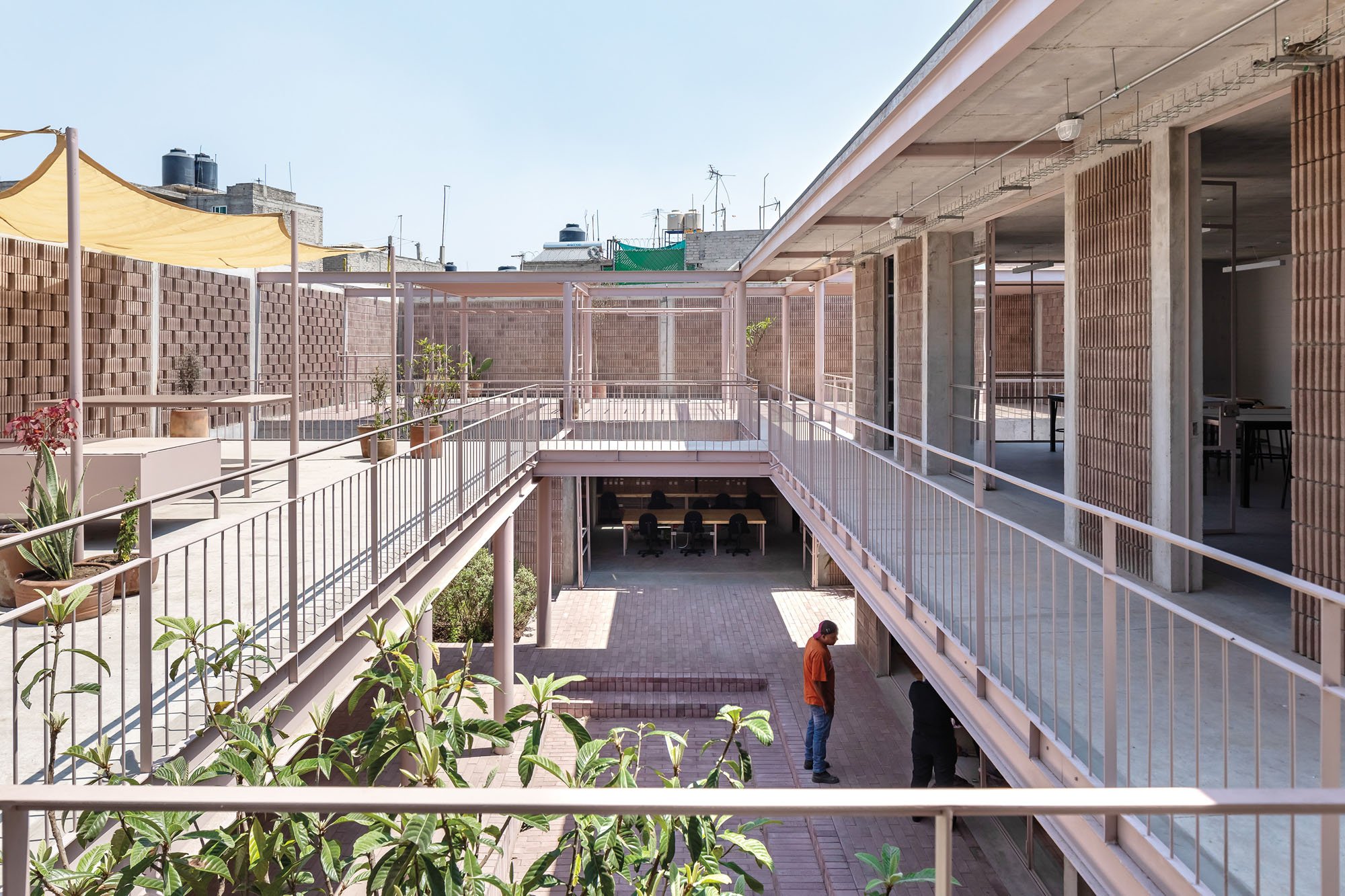 a photograph of an exterior patio space with pink railings