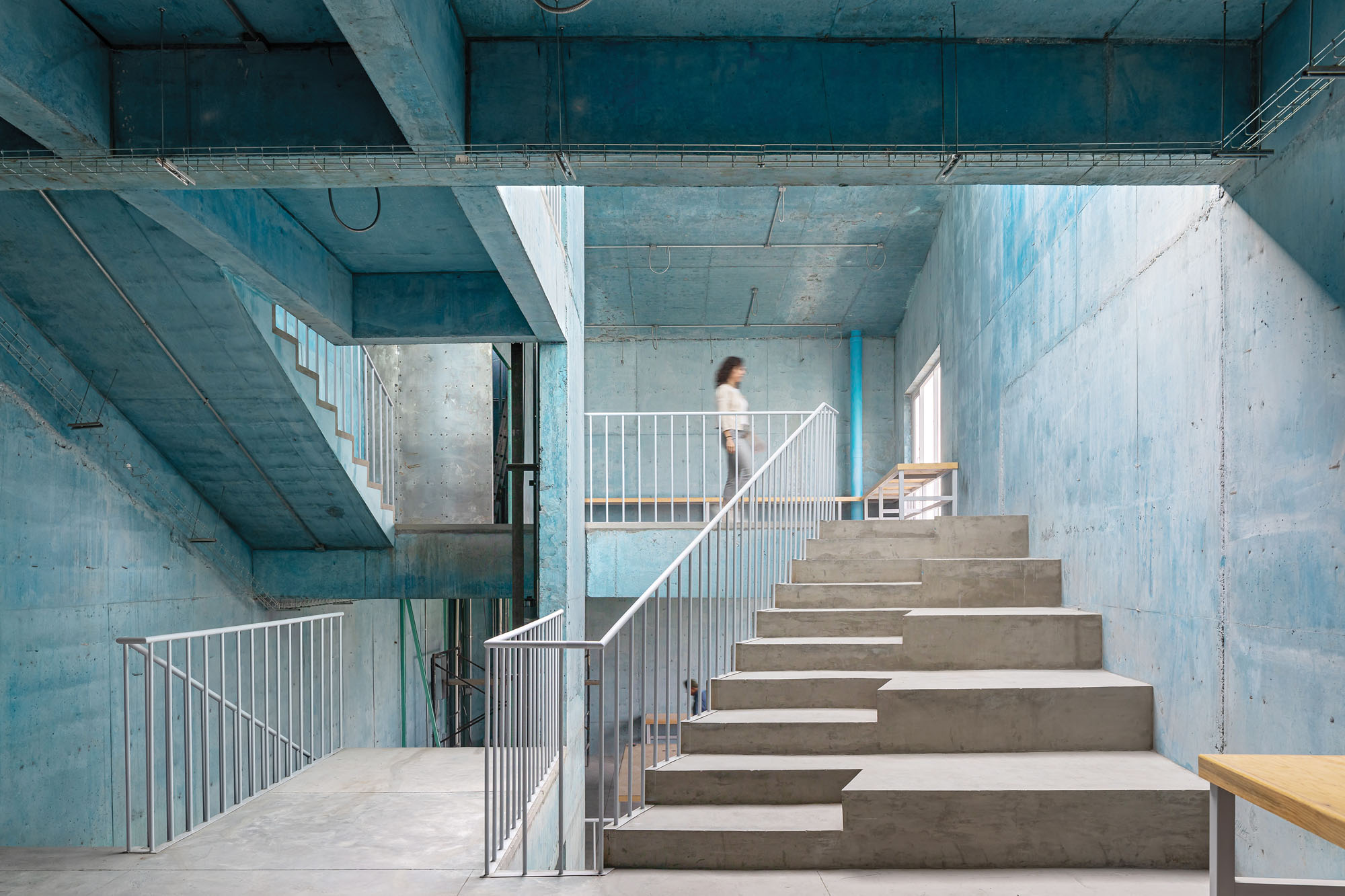 a photograph of the interior of a blue building with staircase in Mexico City