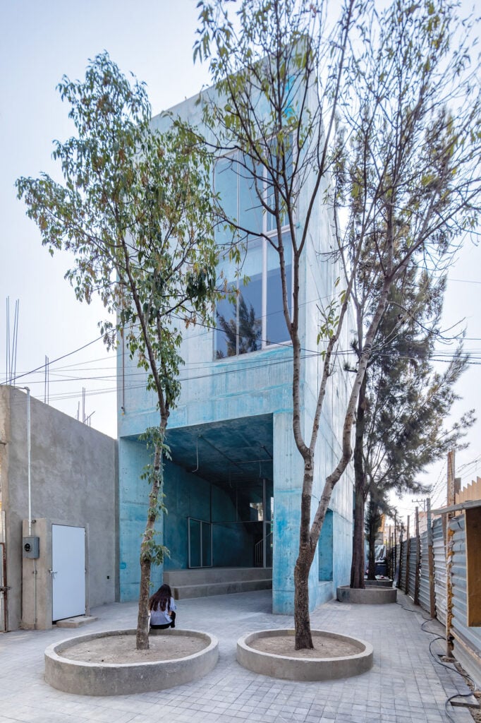 blue building with trees in front in mexico city