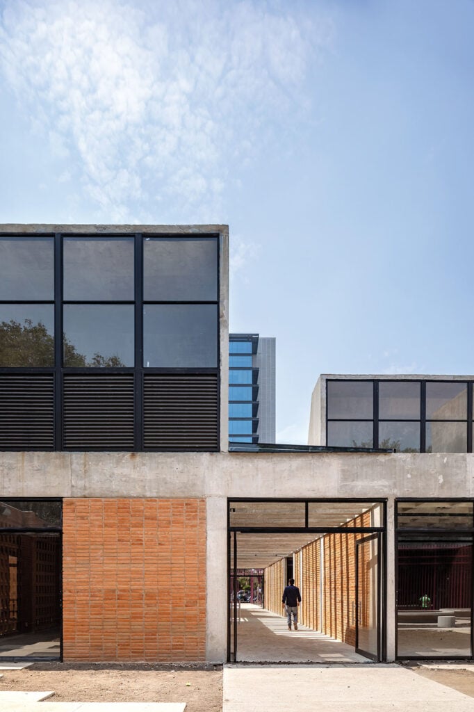 a photograph of a glass, brick, and cement building in mexico city