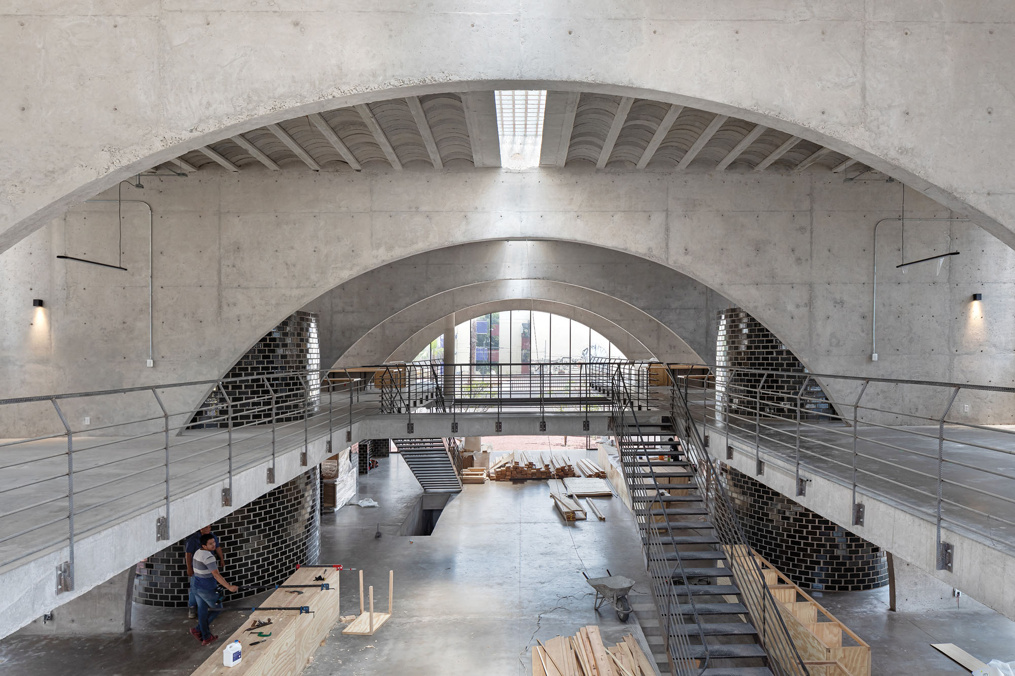 a photograph of the arched concrete interior of a pilares building in Mexico City