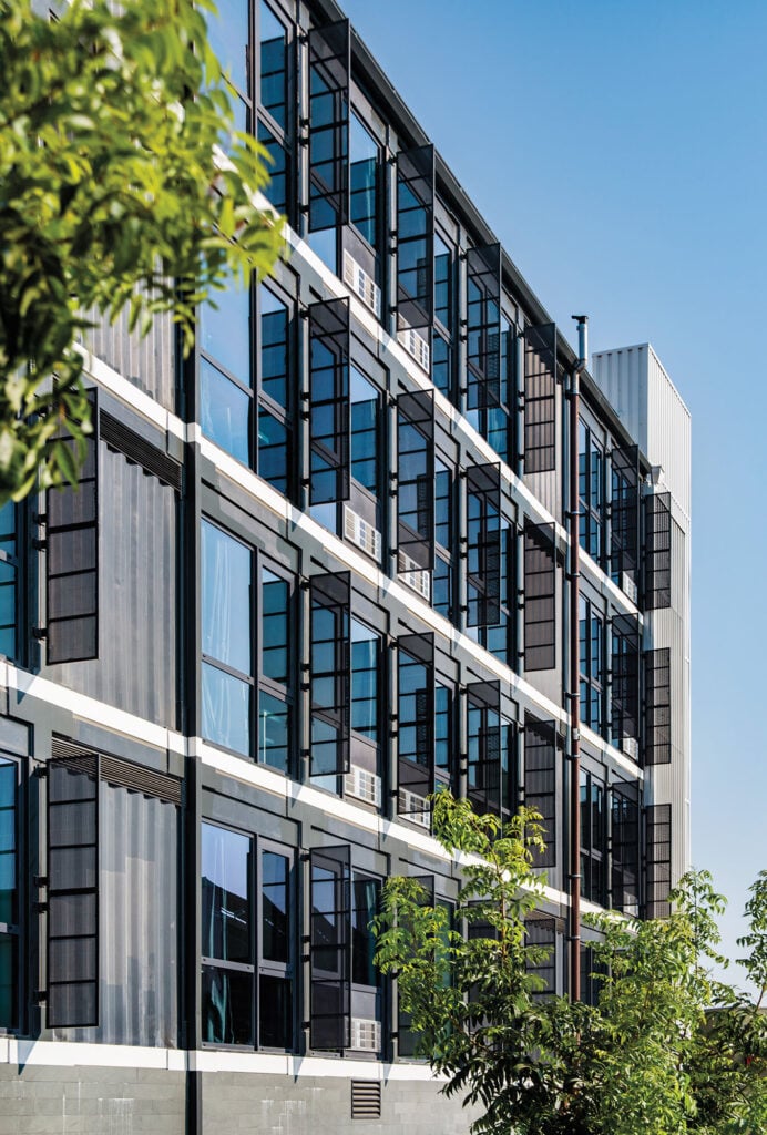 exterior of apartment building with windows and shades