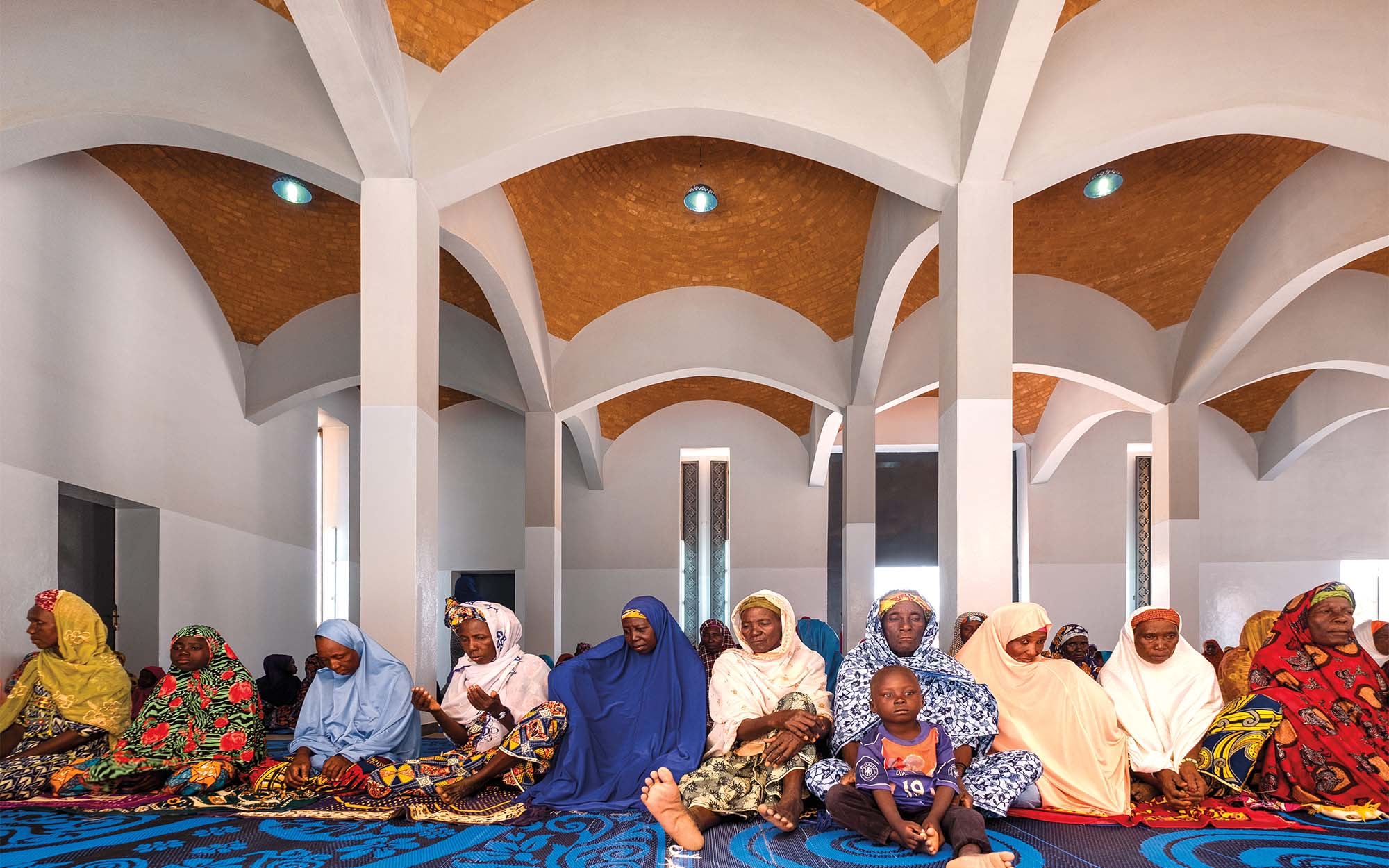 interior of mosque, people praying