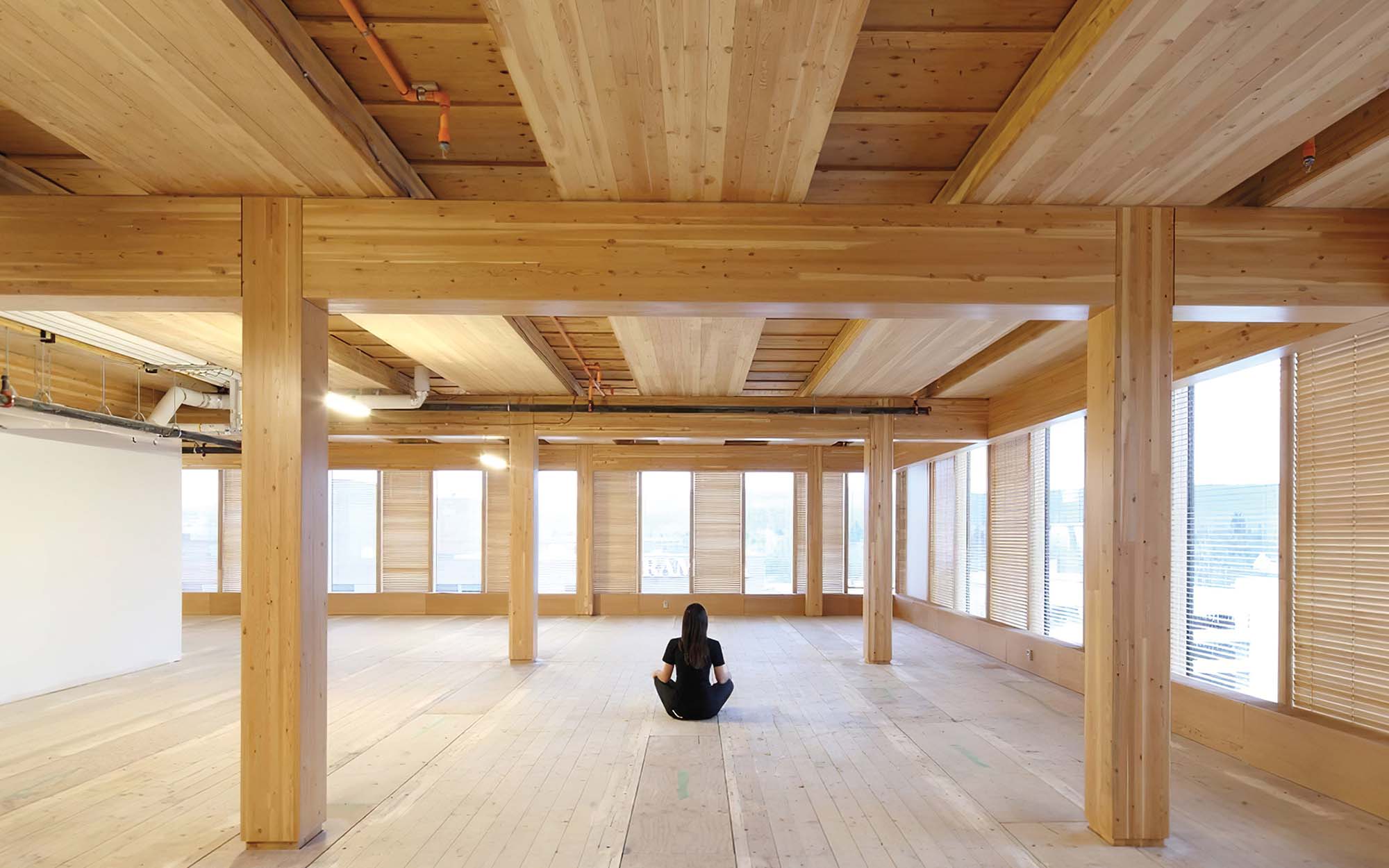 a photograph of a person sitting in a room made of wood