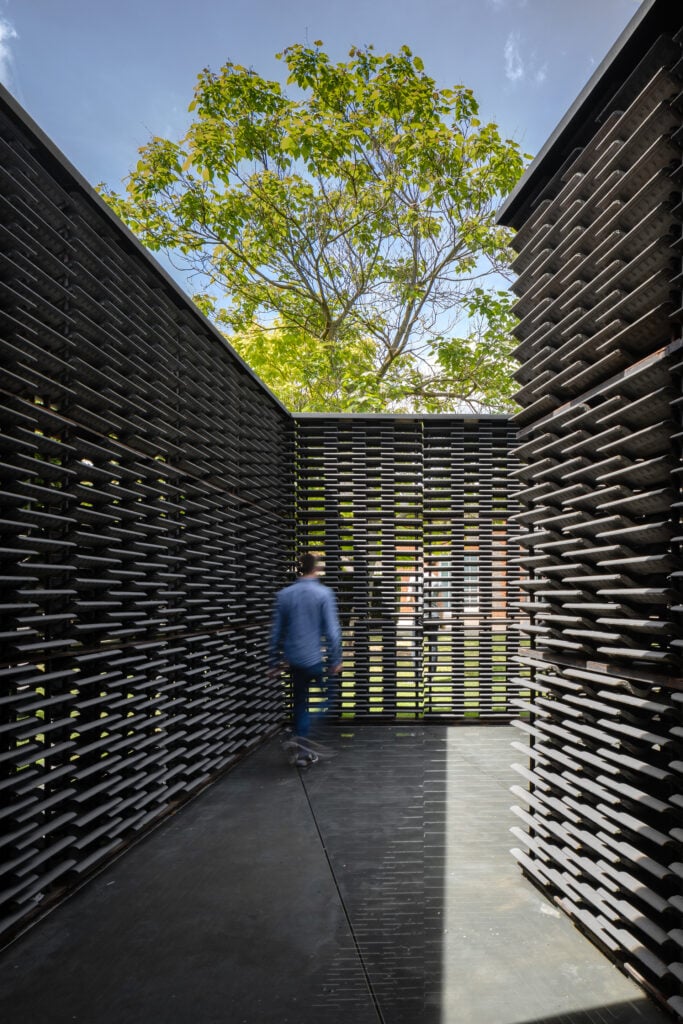 a man walks through the serpentine pavilion