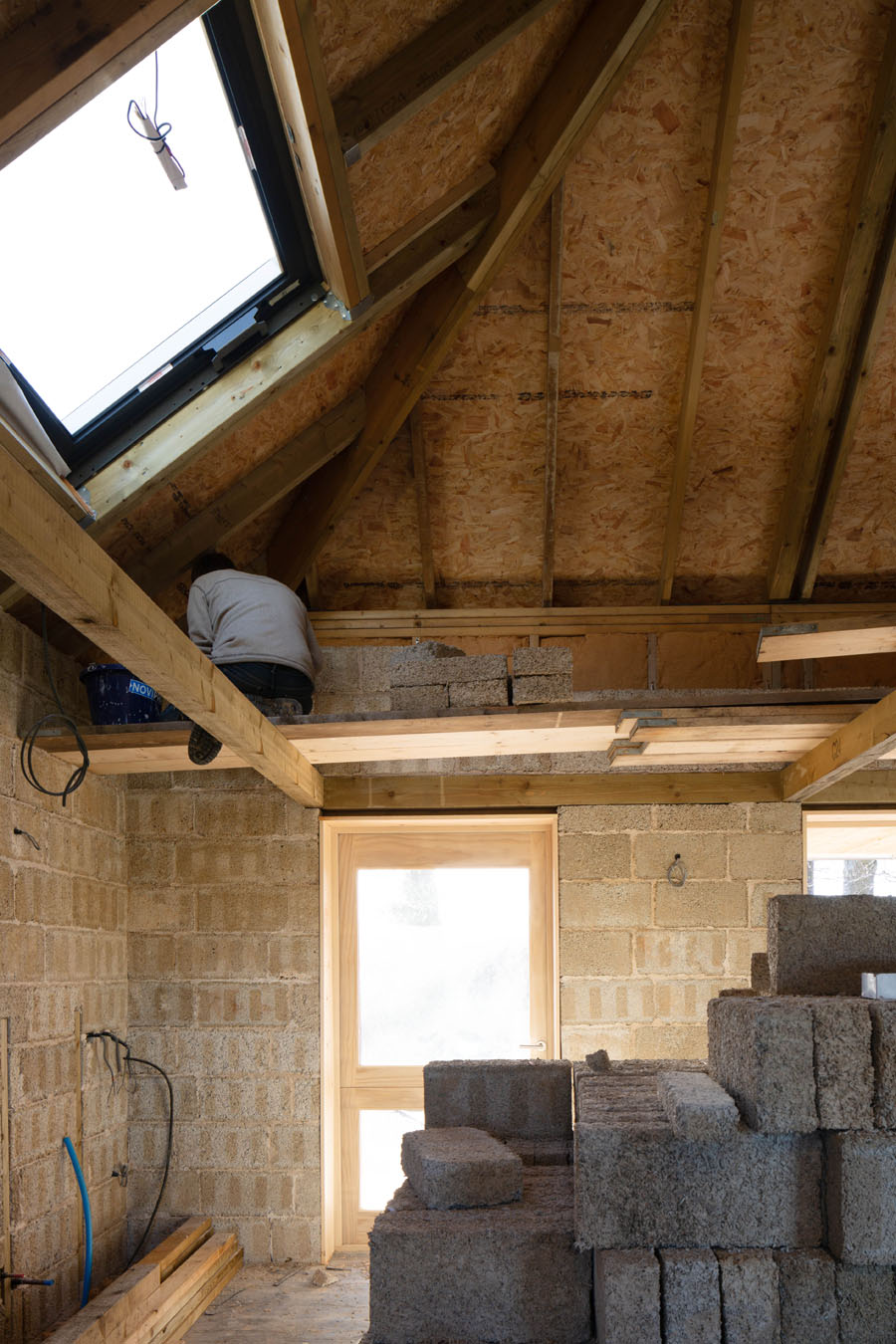 image of someone constructing a house out of hempcrete 