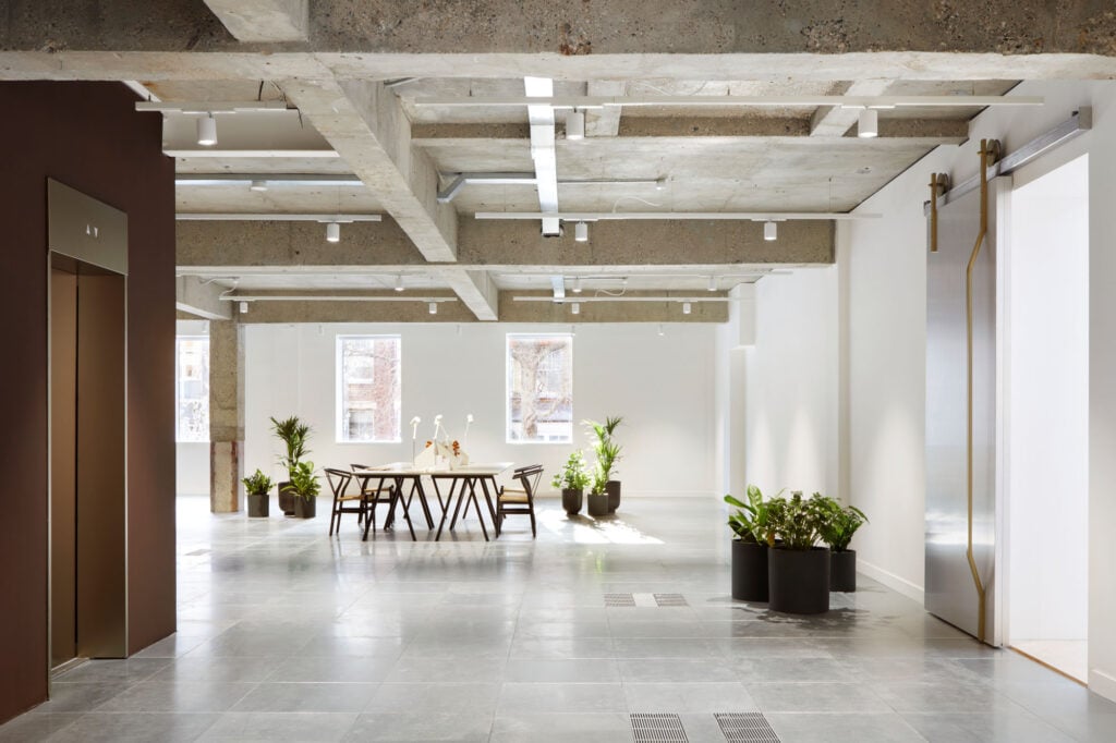 cement-clad interior with table and chairs.