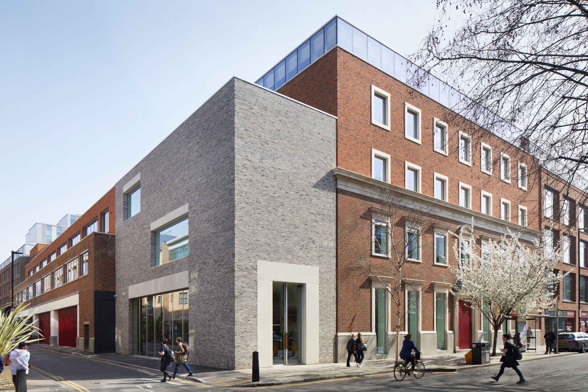 exterior of red brick building and gray addition