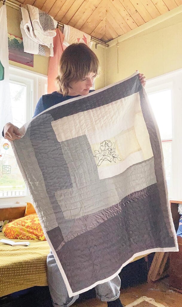 Person holding one of their quilts