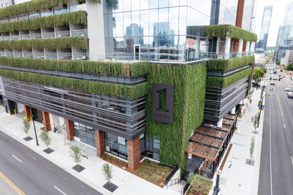 Photograph of the facade of a hotel covered in ivy