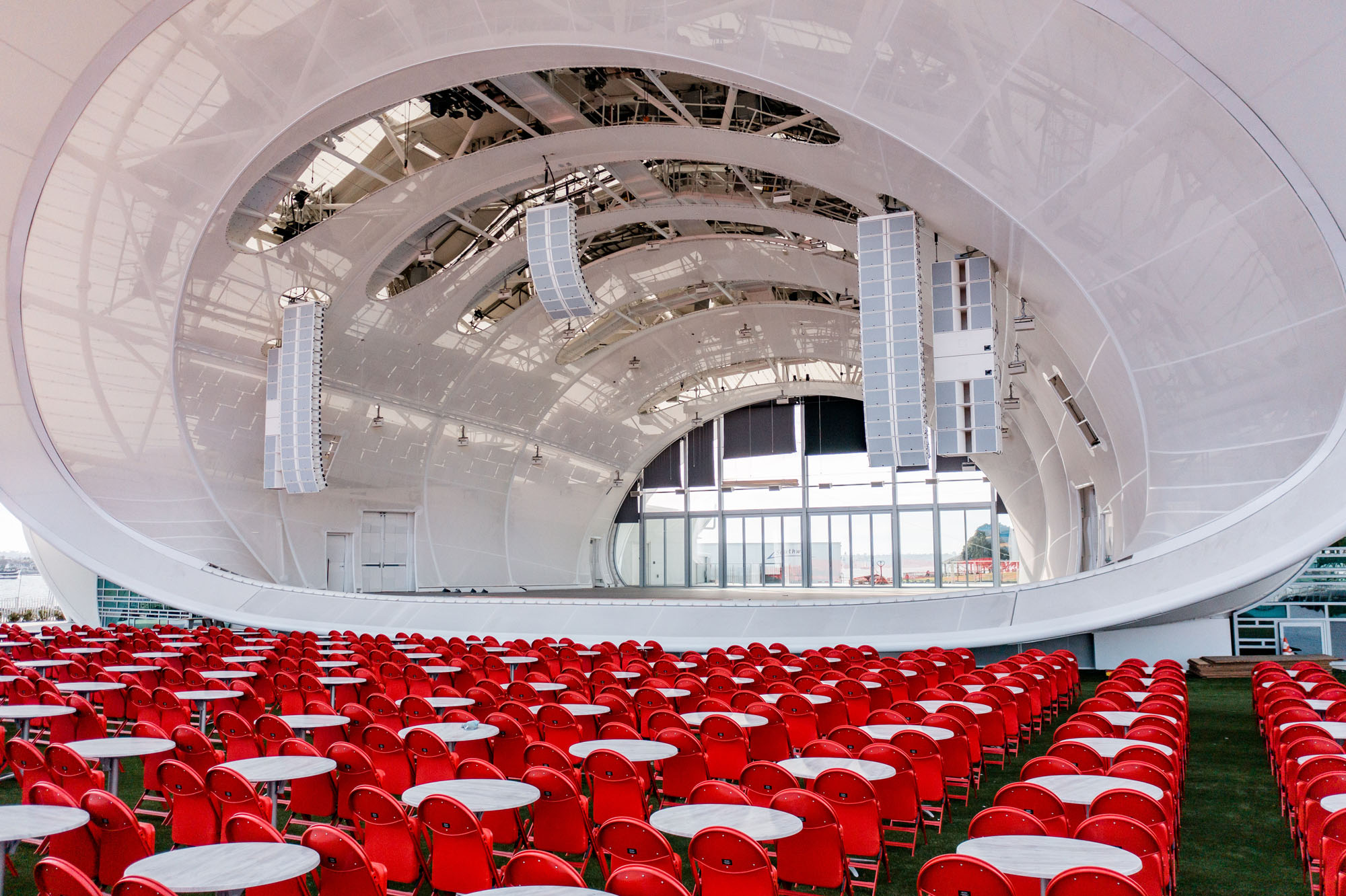 stage of the bandshell with red chairs in foreground