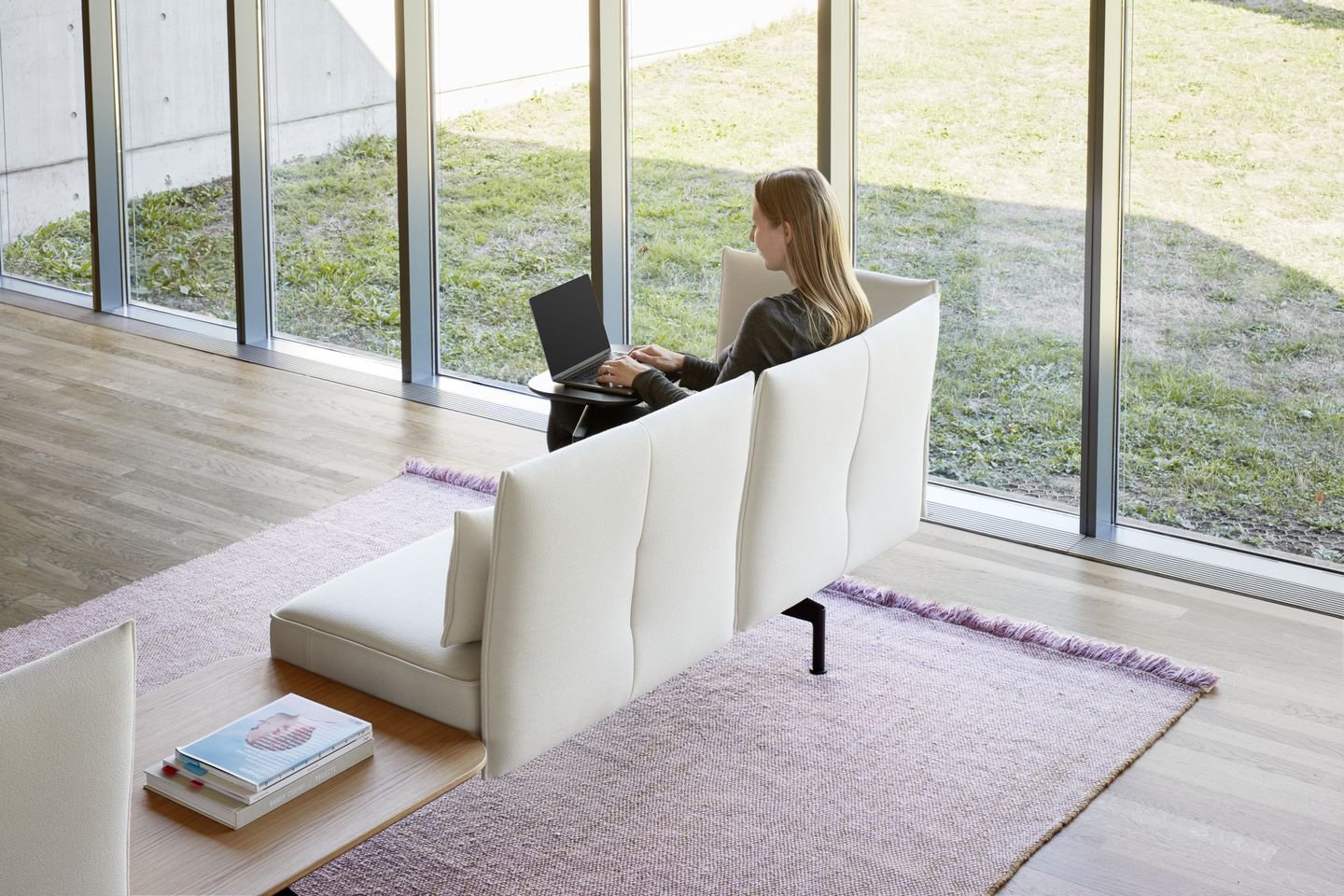 Woman using a laptop computer on a softa