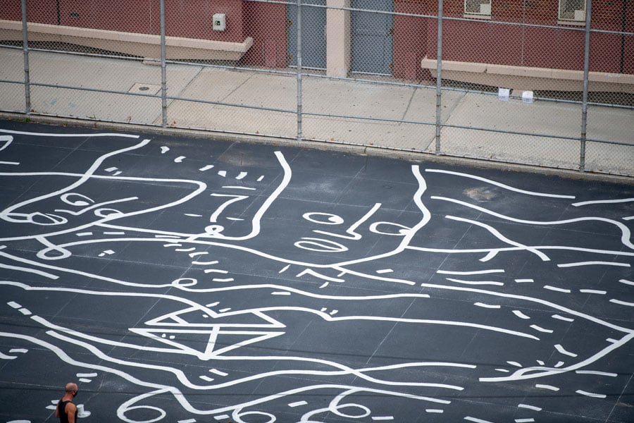 Asphalt playground in Seaside Queens, NY, covered in white painted line drawings by Shantell Martin.