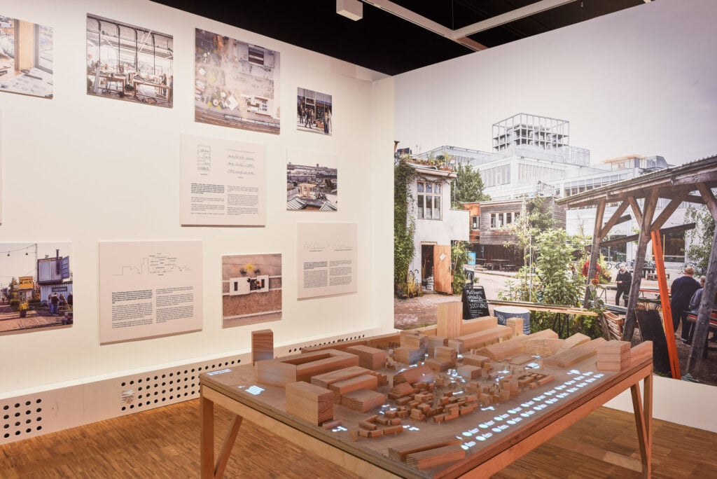 architectural model surrounded by posters