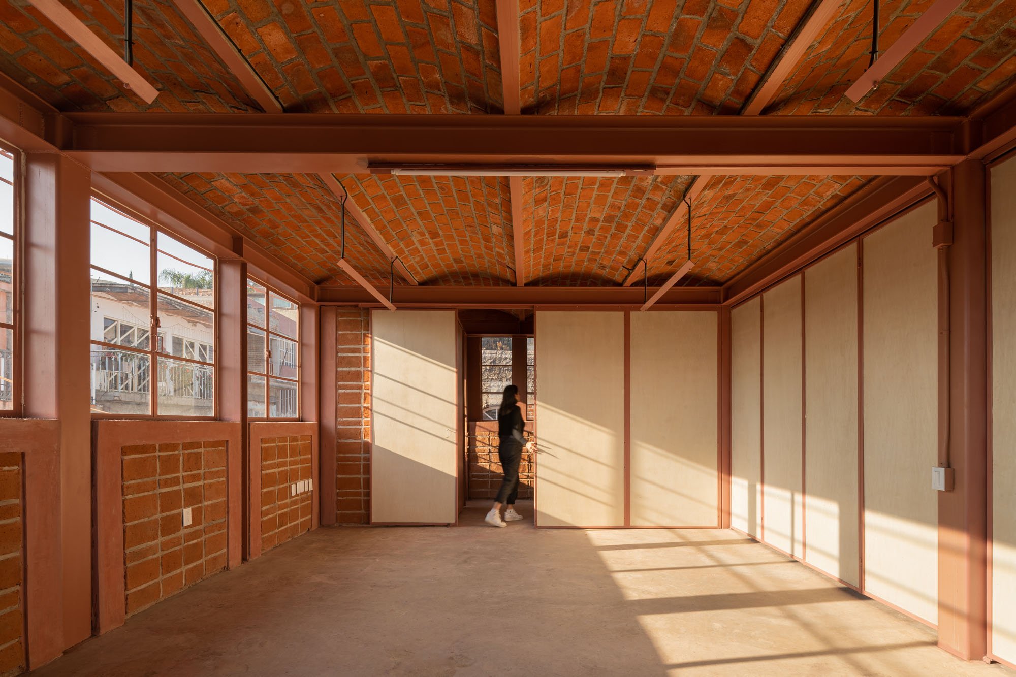 interior of a building with exposed brick walls and vaulted ceilings