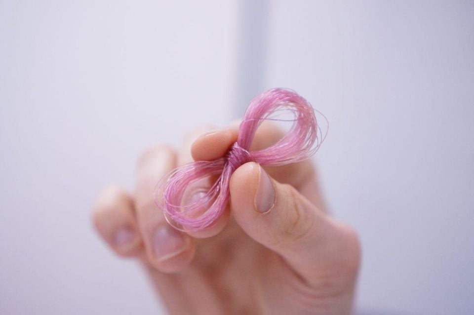 a hand holding a thread sample