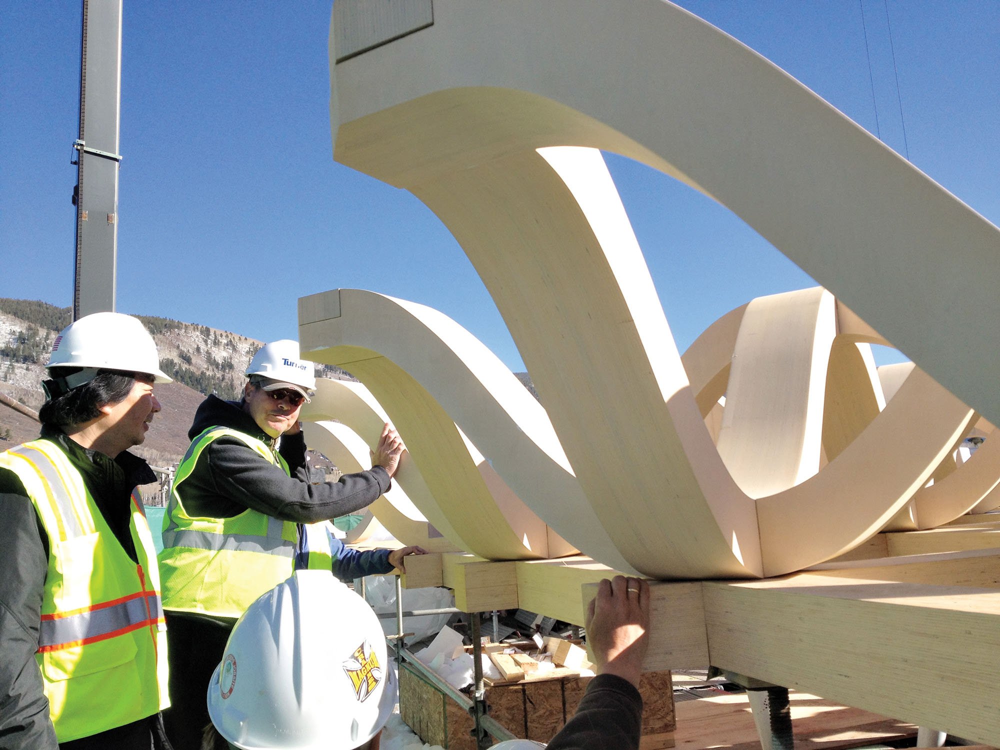 Shigeru ban inspects wooden structural components