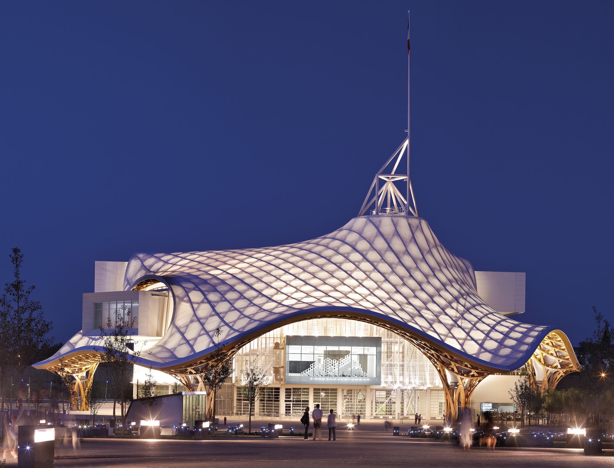 the exterior of Shigeru Ban's Centre Pompidou in Metz features a translucent roof with a visible wooden lattice system