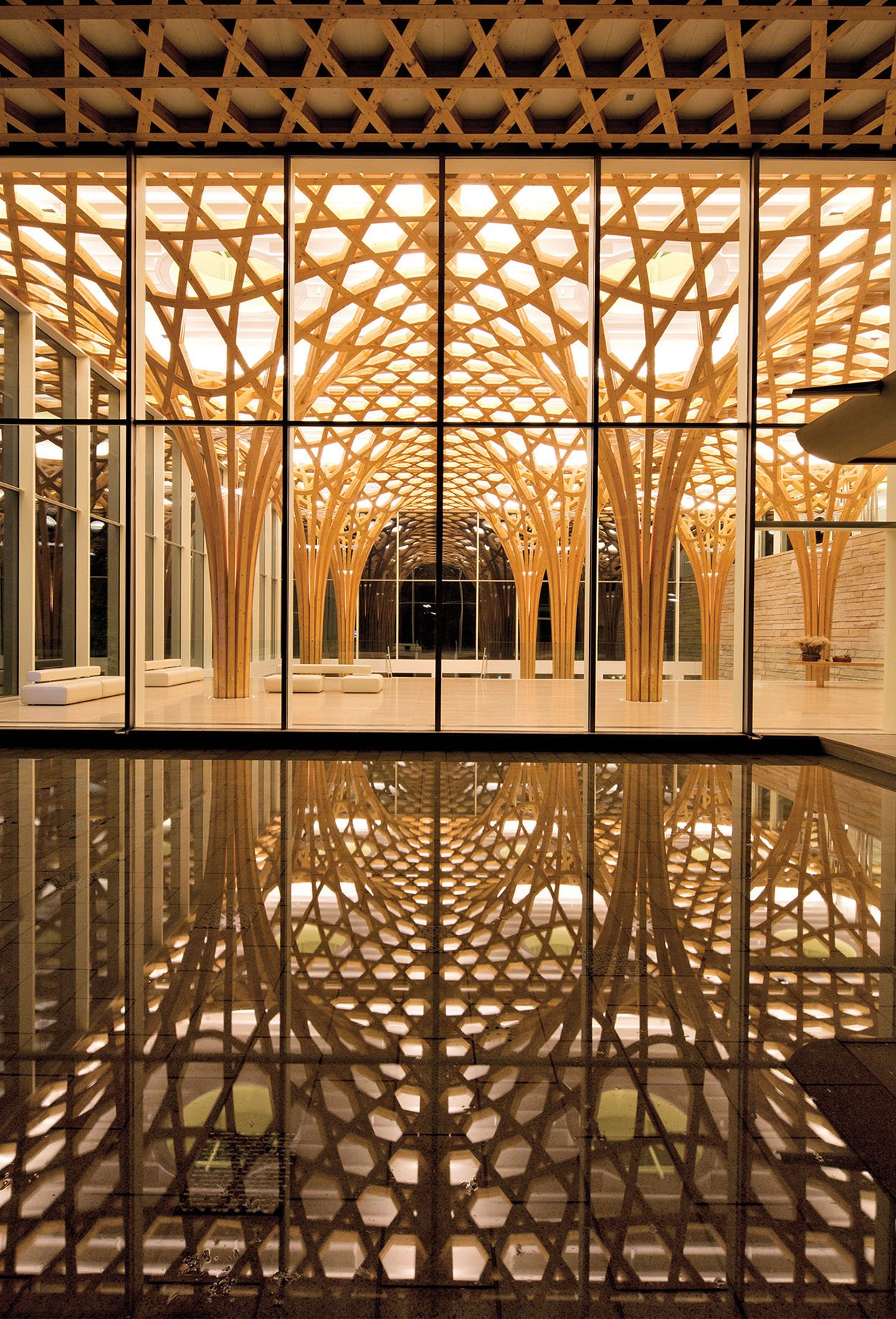 wooden latticework by shigeru ban is reflected in a pool at the Halsey Nine Bridges Golf Clubhouse in Yeoju, South Korea