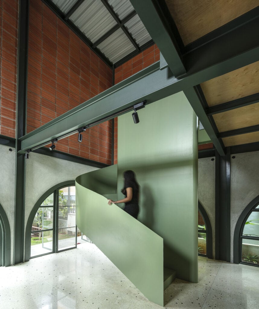 a green stairwell inside the office of Taliesyn Architecture and Design