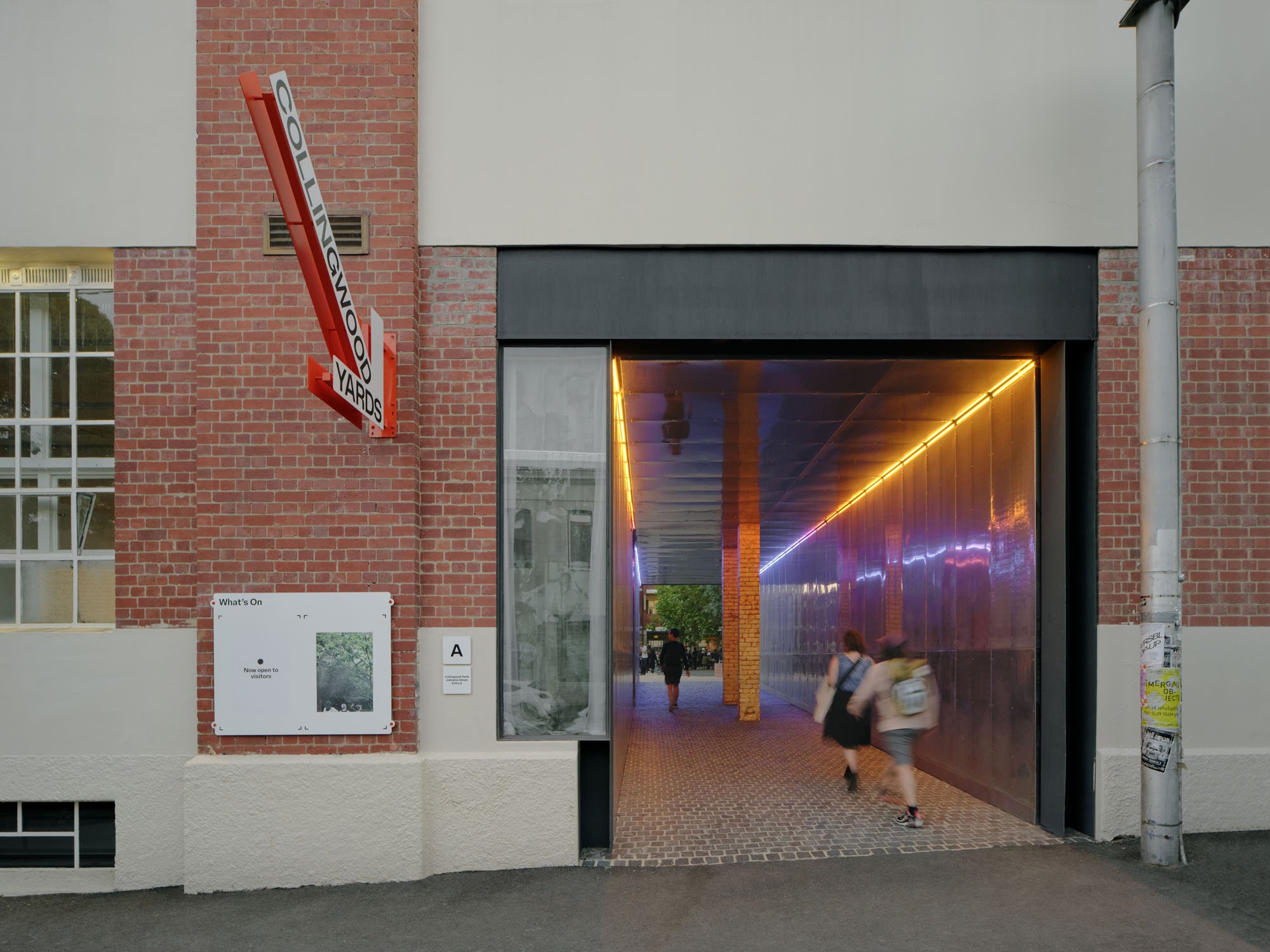 a hallway through a brick building