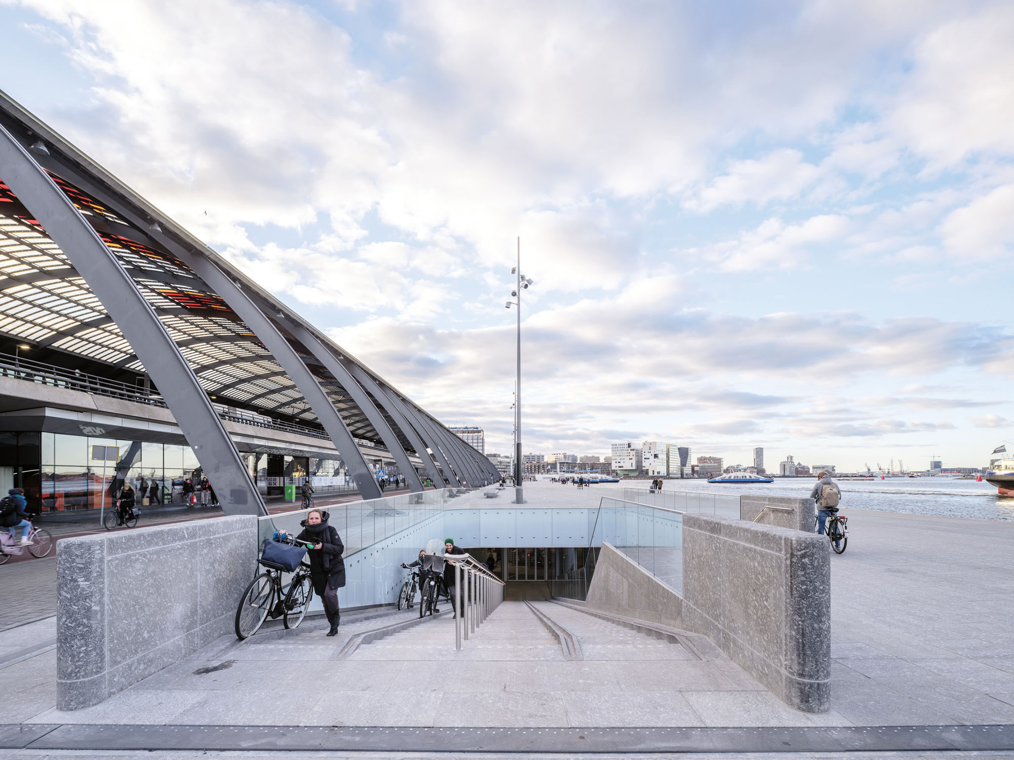 a ramp leads to the underwater bike parking lot designed by VenhoevenCS