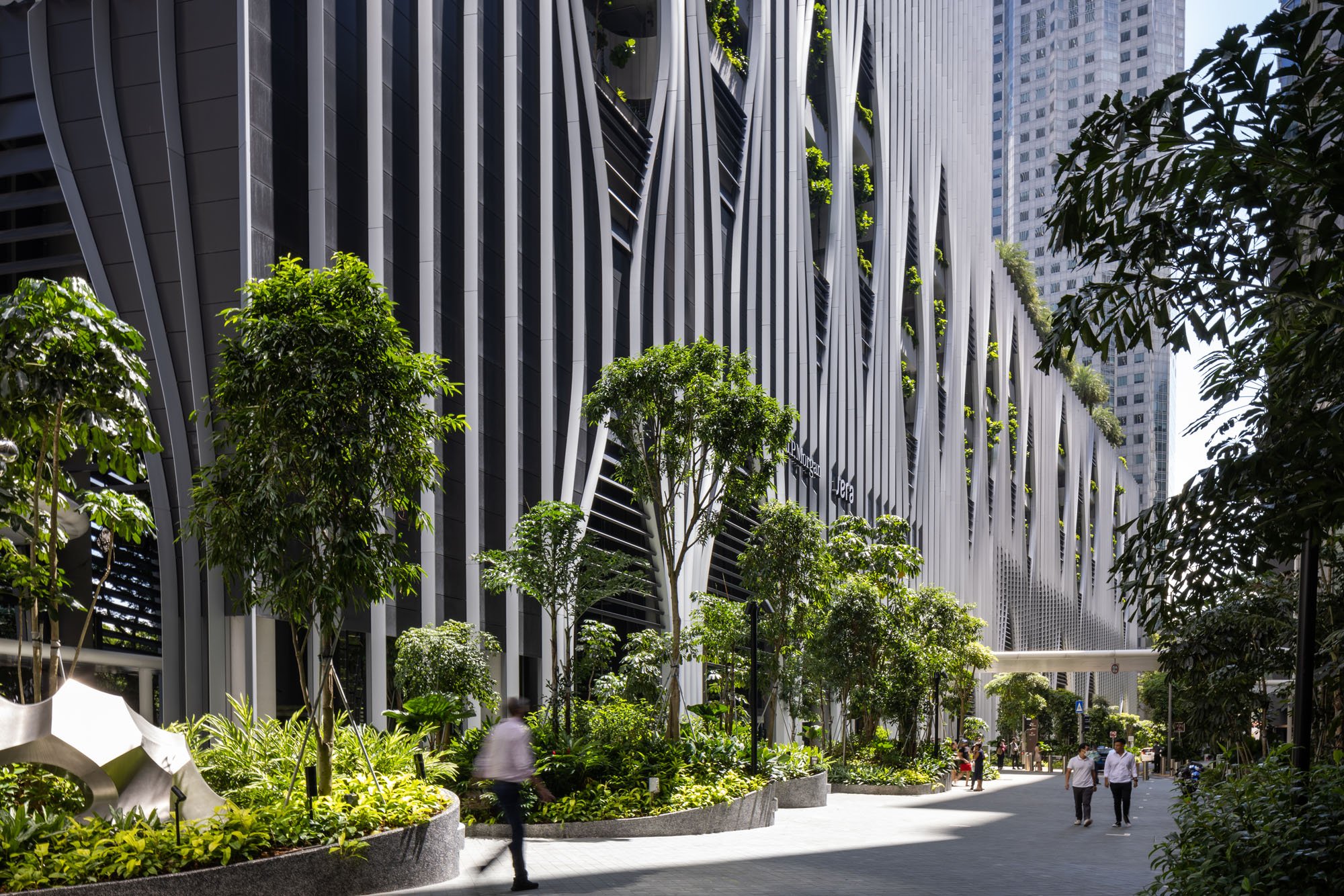 example of Singapore design in this lush garden with the facade of a skyscraper interspersed with trees