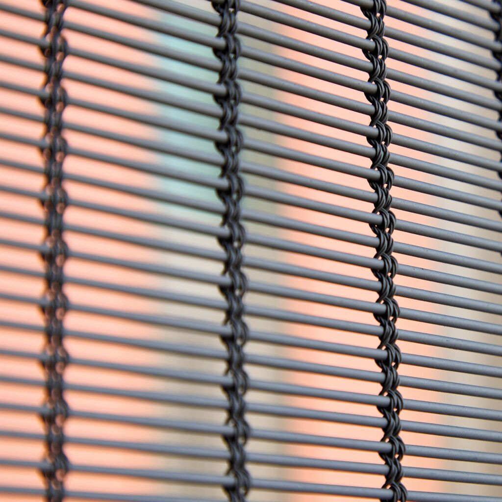 A close up of a mesh blind made with metal and tied together with metal like threads. 