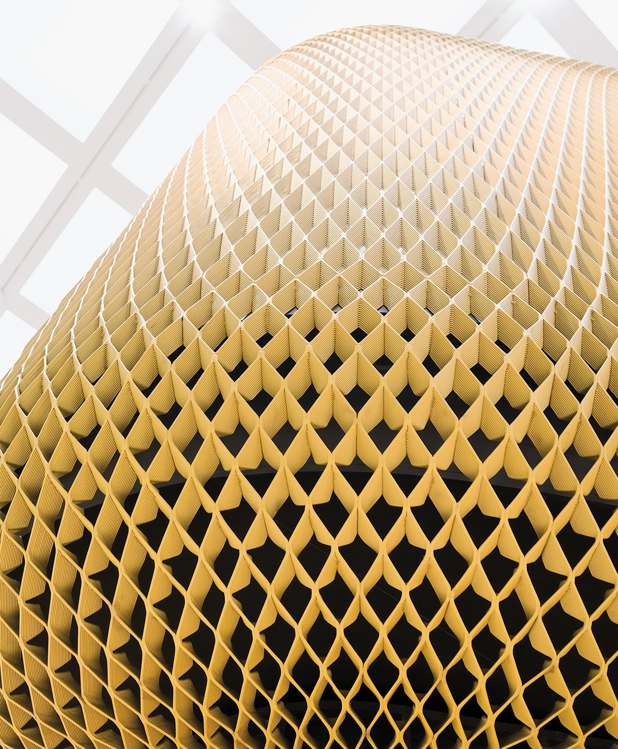 A bottom zoom view of the 3D printed origami structure in yellow showing its interior details and structure. 