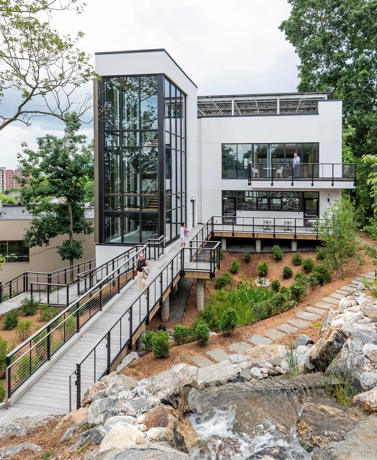 Exterior of the HMTX headquarters building with a long wooden pathway leading to the building.