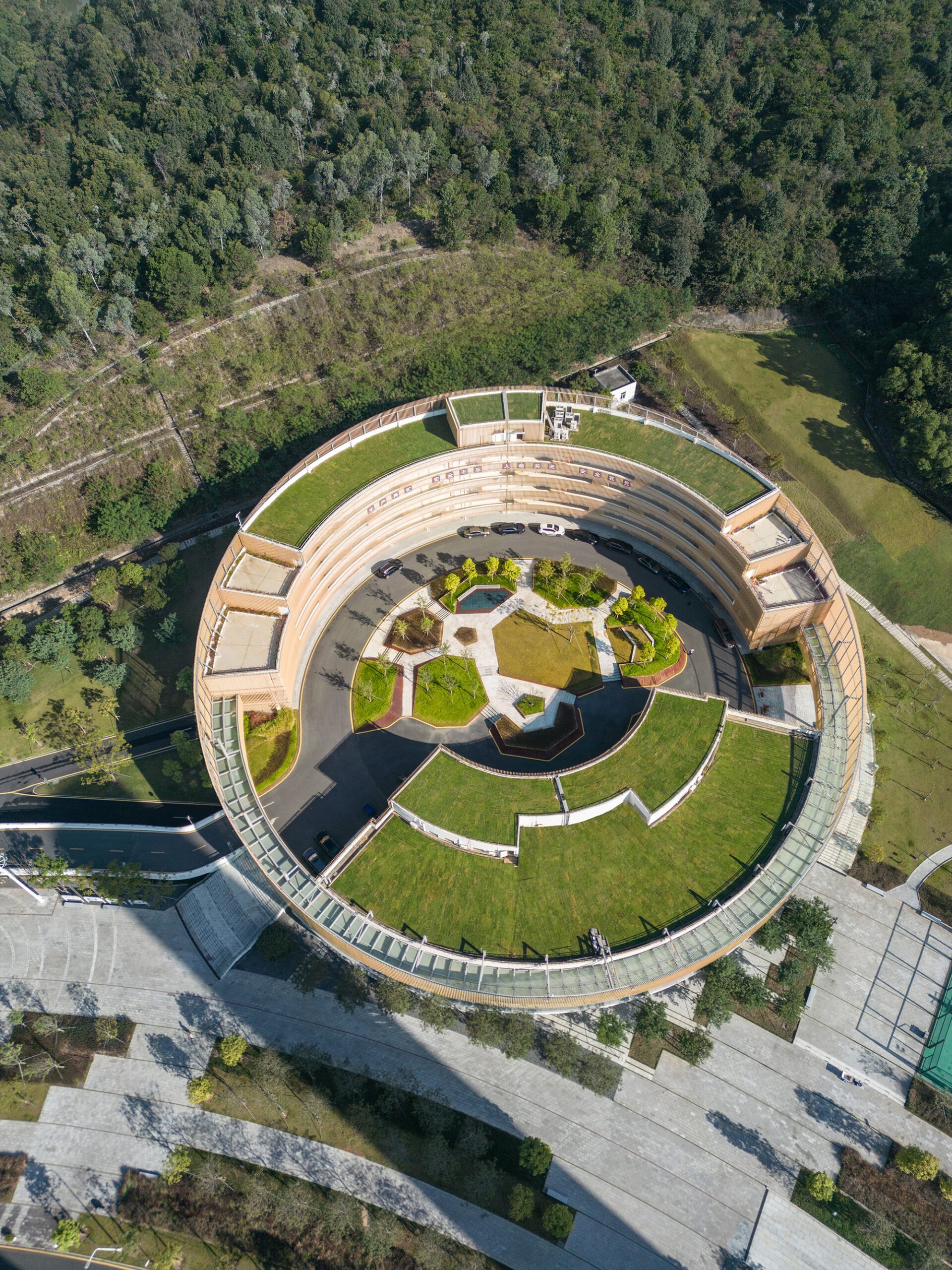 Top aerial view of shenzhen energy ring with lush green gardens and walking path.