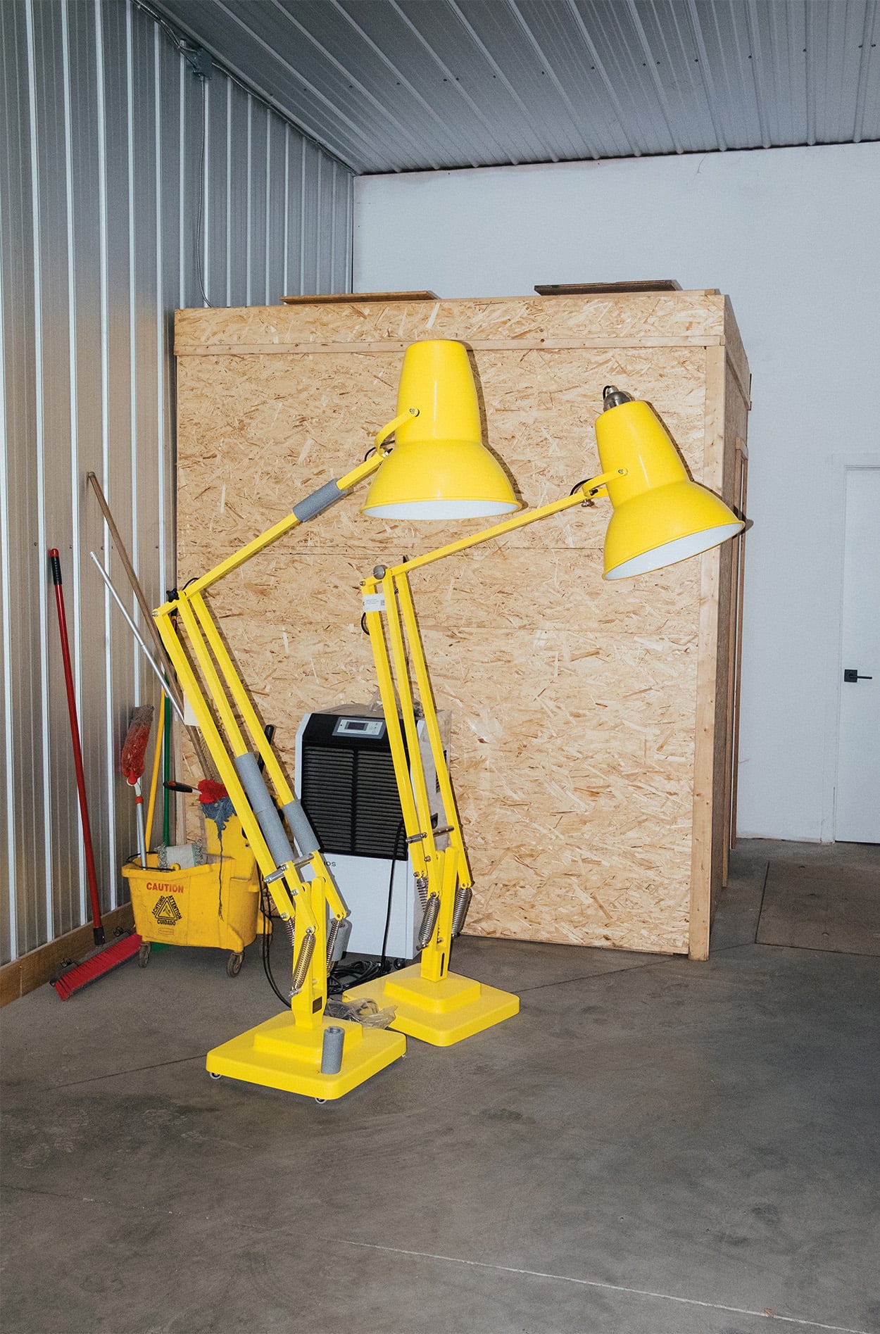 A pair of 2 stark yellow floor lamps. 