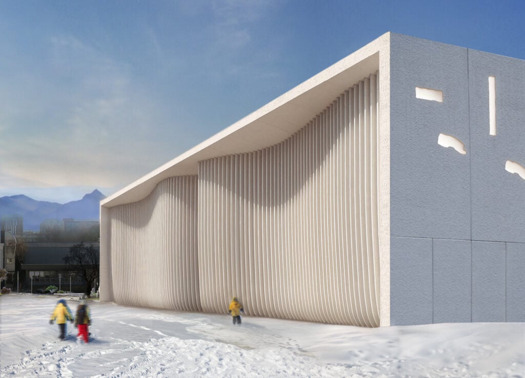 A snowy exterior of a stark white building with curvy facade added to a clay white box like building structure.