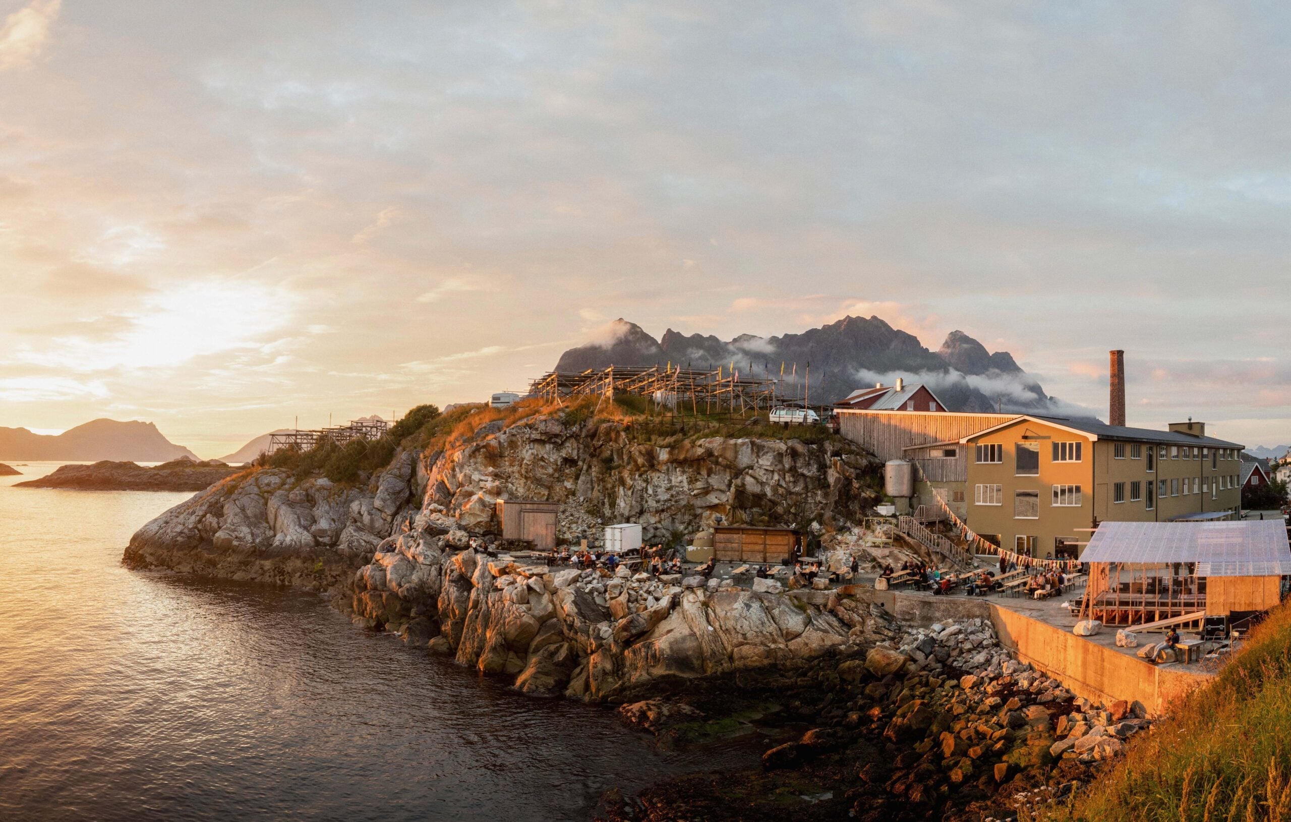interior of a hillside construction site along the water with mountains in the background in norway